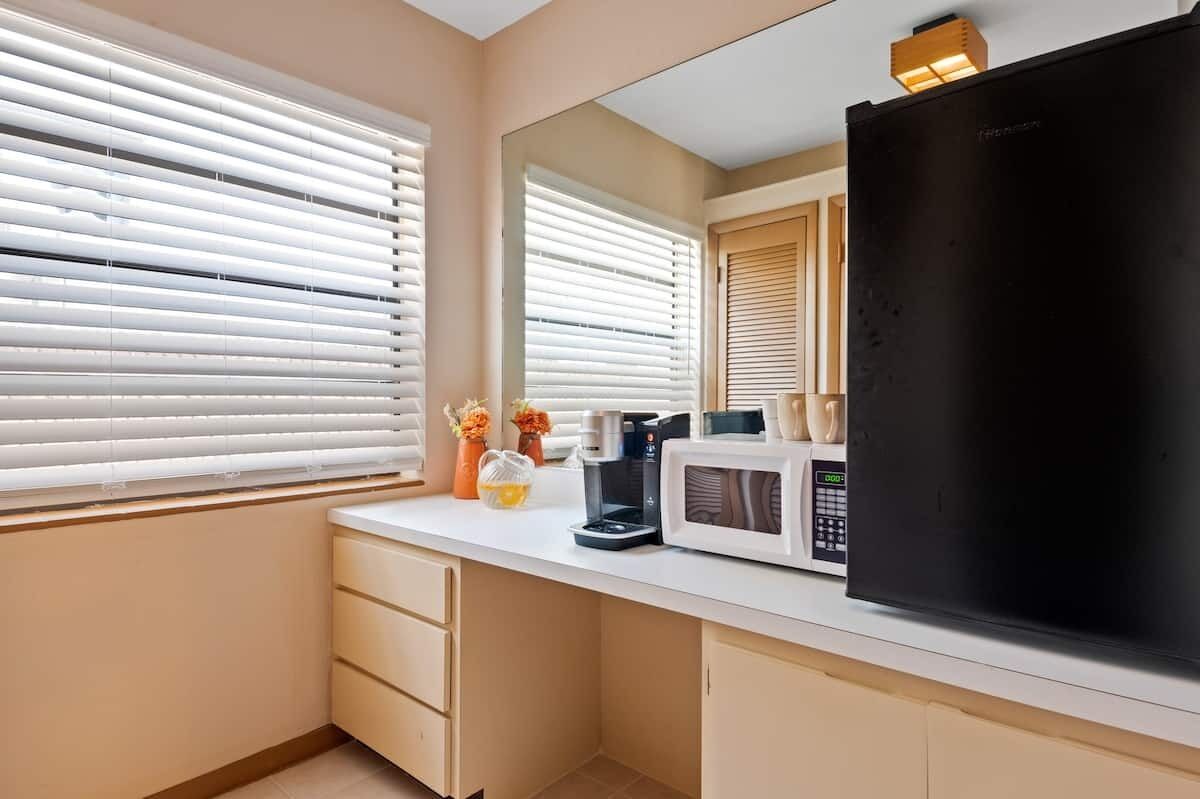 premium studio, pool view | coffee and/or coffee maker