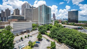 A cityscape with modern buildings, including a prominent office building labeled "Cristo Rey."