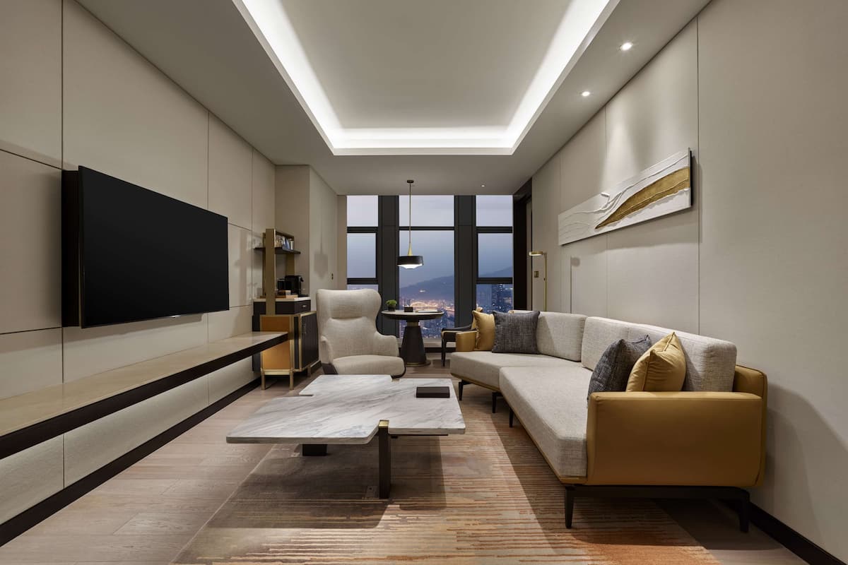 Deluxe Suite, 1 King Bed | Living area | 50-inch TV with digital channels