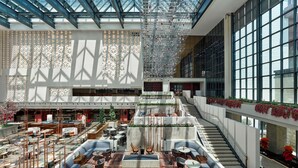 A spacious atrium with a high ceiling, multiple seating areas, and a staircase leading to upper floors. - Hilton Shigatse (Shigatse)