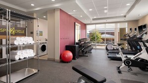 A gym with exercise equipment, a spinning bike, and a bench. - Home2 Suites By Hilton Tupelo, Ms (Tupelo)