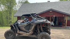 A quad bike parked in front of a building with a sign reading "Piperhaus."