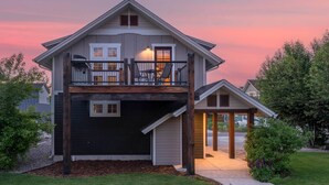 A two-story house with a balcony, a covered porch, and a garage. - Mountain Studio - luxury finishes in upscale neighborhood, e-bikes included! (Bozeman)