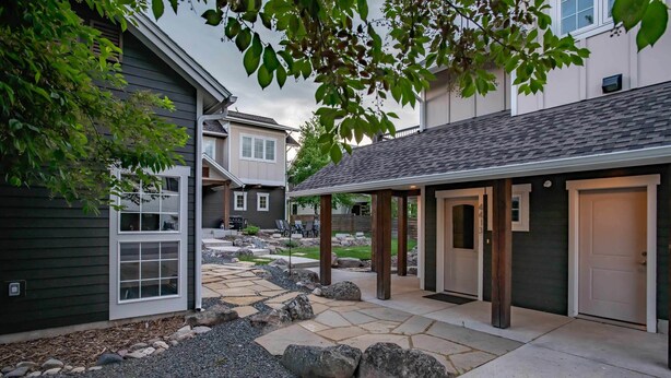 A residential area with a stone pathway, a covered patio, and a garage door. - Mountain Studio - luxury finishes in upscale neighborhood, e-bikes included! (Bozeman)