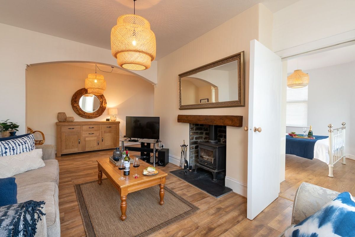 Open-plan living area with double bedroom beyond, pet-friendly holiday apartment in the heart of Rhosneigr, Anglesey