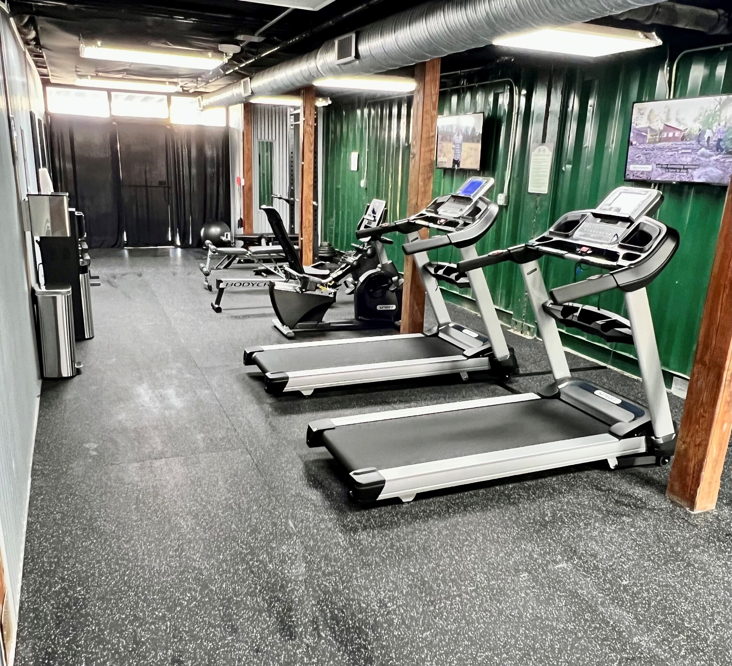 A gym with treadmills and exercise equipment.
