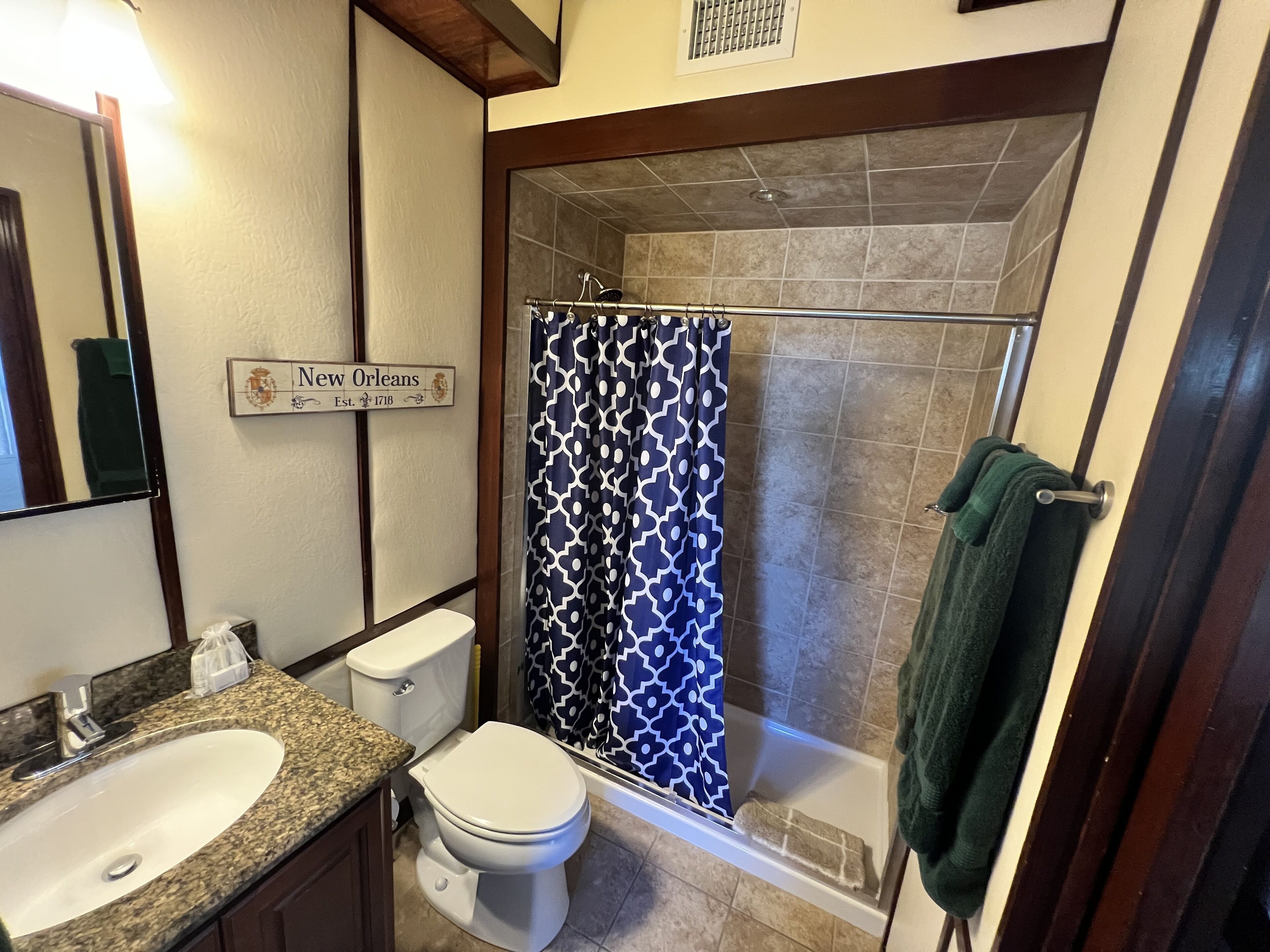 A bathroom with a sink, toilet, and shower.