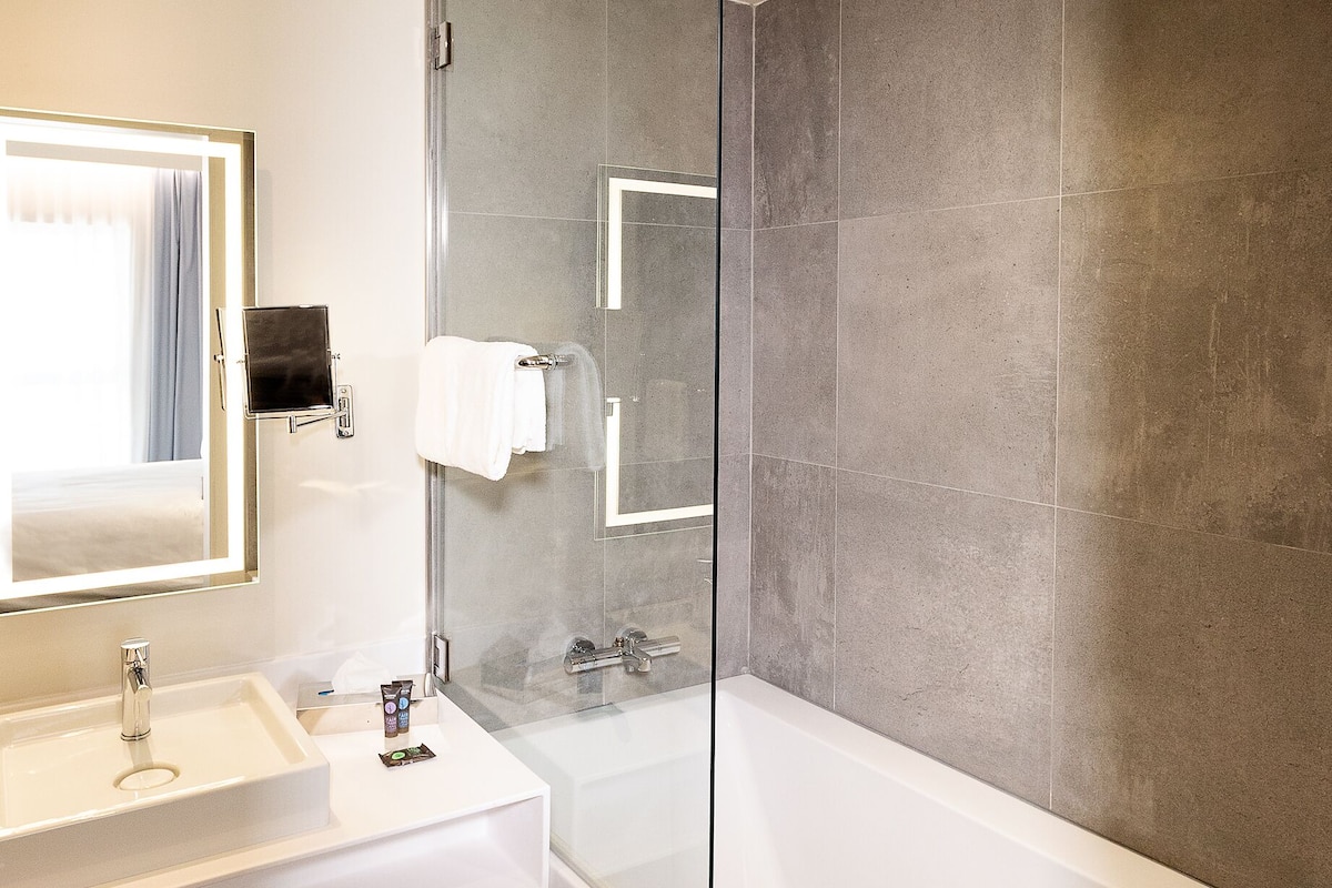 deluxe double room, 1 double bed | bathroom | deep-soaking bathtub, rainfall showerhead, eco-friendly toiletries