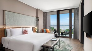 A modern hotel room with a large bed, a flat-screen TV, a balcony with a view of the city, and a dining area. - Hotel Indigo Suzhou Yangcheng Lake by IHG (Suzhou)