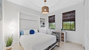 A modern bedroom with a bed, bedside tables, a desk, and a window with blinds. - * Welcome to Relaxa * (Naples)