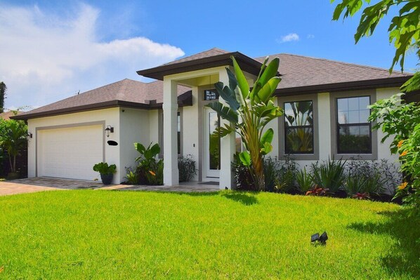 A modern two-story house with a garage, large windows, and a well-maintained lawn. - * Welcome to Relaxa * (Naples)