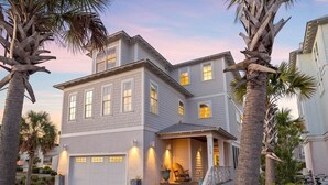 A two-story house with a garage, a covered porch, and a driveway. - 1 HOUSE OFF BEACH w/ LSV, BIKES, POOL & GULF VIEWS! PET FRIENDLY! (Santa Rosa Beach)