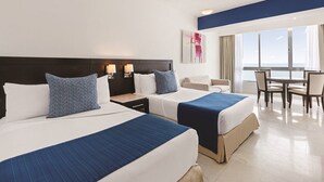 A hotel room with two beds, a dining area, and a large window with a view. - Private Junior Suite with a Short Ride Away from Beach (Marina Mazatlán)