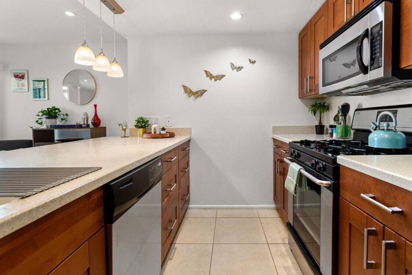 A modern kitchen with wooden cabinets, stainless steel appliances, and a central island.