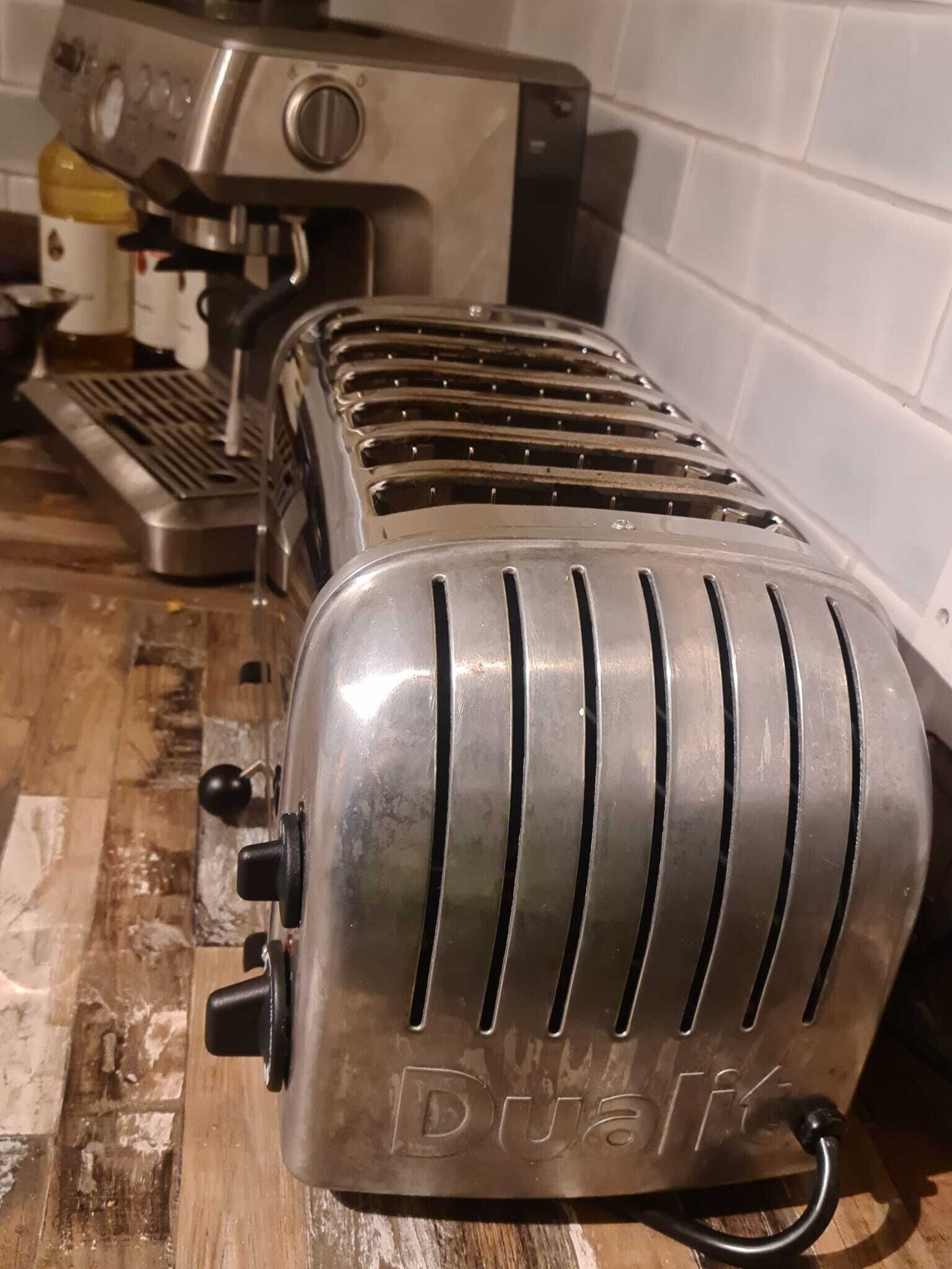 A kitchen with a toaster and a coffee maker on the counter.