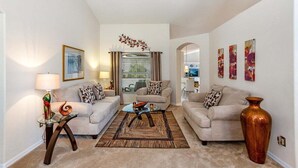 A living room with two sofas, a coffee table, a lamp, and a vase.