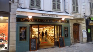 A storefront with a sign reading "Maison Bremond 1830" and "Épicerie Fine."