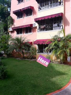 Stunning two-story building with a balcony and lush surroundings.
