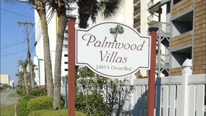 A sign for Palmwood Villas at 2405 S. Ocean Blvd. - Direct Oceanfront Corner Unit Villa, 2BR 2Bath, large pool, million dollar view! (North Myrtle Beach)