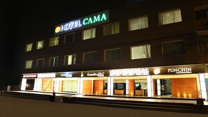 A hotel named HOTEL CAMA with a 24x7 service sign, a Punchin restaurant, and a visible entrance. - Cama Hotel (Mohali)