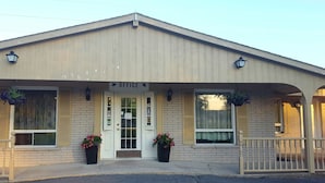 A two-story building with a sign reading "OFFICE" above the entrance. There are two large windows on the ground floor and a balcony with railings. - OYO First Canada Hotel Cornwall Hwy 401 ON (Cornwall)
