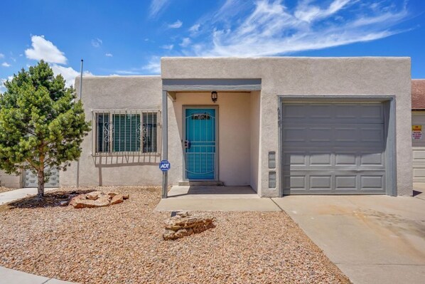 A single-story building with a blue door and a garage door.