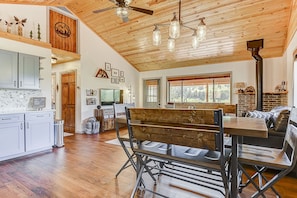 Cozy dining area with fireplace, wooden bench, and modern cabinetry.