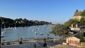 A marina with numerous boats docked, a bridge, and a building with a sign "La Fraisierie." - Seaview, Ocean view, villa on the historical harbor, city center (Pornic)