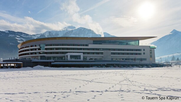 A modern building with a curved roof, surrounded by snow and mountains. - Wildkogel by Interhome (Neukirchen am Großvenediger)