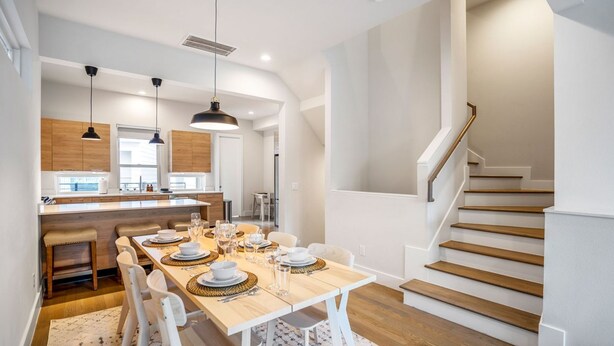 A modern kitchen with a central island, wooden cabinets, and pendant lighting. - Ethereal Rooftop Retreat - 1 km from FIFA Fest (Houston)