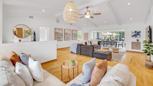 A spacious living area with a modern sofa set, a dining table, and a ceiling fan. - Private Corner Oasis with Heated Saltwater Pool (Palm Coast)