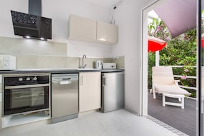 A modern kitchen with stainless steel appliances, a built-in oven, and a dishwasher.