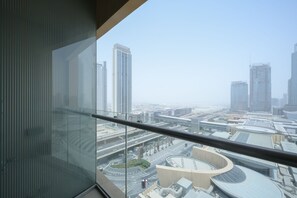 A high-rise building with a view of a cityscape, including several tall buildings and a roundabout.