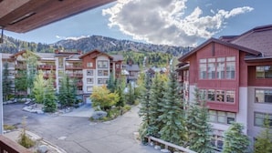 A view of a building with multiple balconies and a courtyard with trees. - First Tracks (with AC unit!) by Cottonwood Lodging (Solitude)
