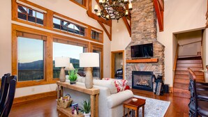 A spacious living room with a fireplace, large windows, and a cozy seating area. - Breathtaking View - Fabulous & Well-Stocked Kitchen - Now renting for October🍁🍂🍁 (Boone)