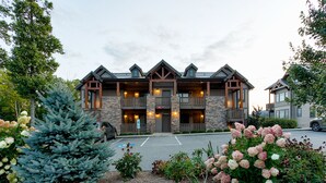 A lodge with a stone facade, multiple balconies, and a parking area. - Breathtaking View - Fabulous & Well-Stocked Kitchen - Now renting for October🍁🍂🍁 (Boone)