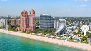 A coastal cityscape with high-rise buildings, a beach, and a marina. - Steps from Beach / Quaint Cottage / Hot Tub / Surf Key / H0MES (Fort Lauderdale)