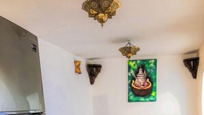 Un salon chaleureux avec un canapé, une table basse et un plateau sur lequel se trouvent une théière et des verres.