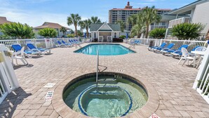 A pool area with a hot tub, lounge chairs, and a 3 FT depth sign. - Shorehaven II 8B-2BR/2BA condo in Cherry Grove (North Myrtle Beach)