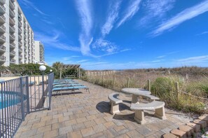 Relax on the paved terrace with lounge chairs and a small dining table, steps from the water.