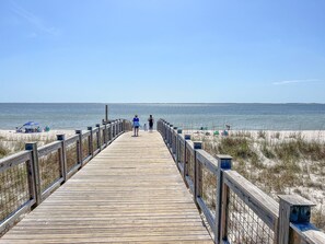 A wooden boardwalk leading to a beach with clear skies. - Steps to Beach | Sleeps 12, Game Room & Bay Views in Windmark (Port St Joe)