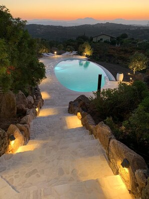 A swimming pool with a stone pathway leading to it, surrounded by rocks and trees. - Stunning Ocean View and Private Pool - 3 Bedrooms - 3 Bathrooms in 2 Houses (MURTA MARIA)