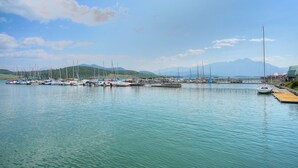 A marina with boats docked, calm water, and a mountainous backdrop. - Luxurious Lakefront Haven - Prime Ski Access & Majestic Mountain Views! (Dillon)