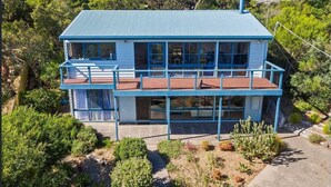 A two-story building with a blue exterior and a flat roof, surrounded by greenery. - BEAUTIFUL BEACH HOUSE - BRILLIANT POSITION (Anglesea)