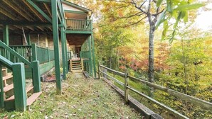 A wooden cabin with a covered porch and a staircase leading to a second level. - Family-Friendly, Private 2 Acres with Stunning Views (Topton)