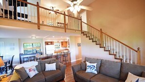 A spacious living room with two sofas, a dining area, and a kitchen in the background. - Family-Friendly, Private 2 Acres with Stunning Views (Topton)