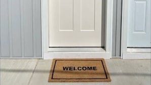 A white door with a small window, a welcome mat, and a number '2' sign on the wall. - GOTL Strip Suite #2- Sunset Vacation Rentals (Geneva)