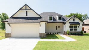 A two-story house with a garage, a covered entryway, and a small front yard. - Executive Stay, Modern Farmhouse Perfect Location. Garage Parking. (Broken Arrow)