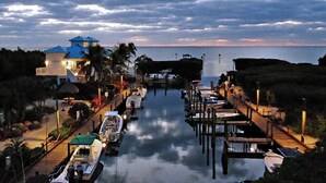 A marina with boats docked, a pier with a building, and a view of the water.