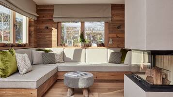 Deluxe Apartment | Living area | 55-inch flat-screen TV with cable channels, TV, fireplace